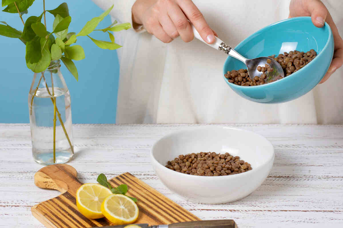 A girl preparing food for the cat at home.