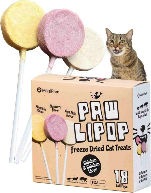Three colorful freeze-dried cat treat lollipops (Pumpkin, Blueberry, Goat Milk flavors) next to a cat and product box labeled "Paw Lipop".