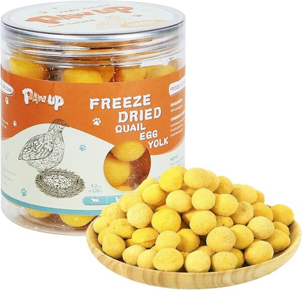 Clear container and wooden bowl filled with freeze-dried quail egg yolk treats for cats and dogs by PawUp.
